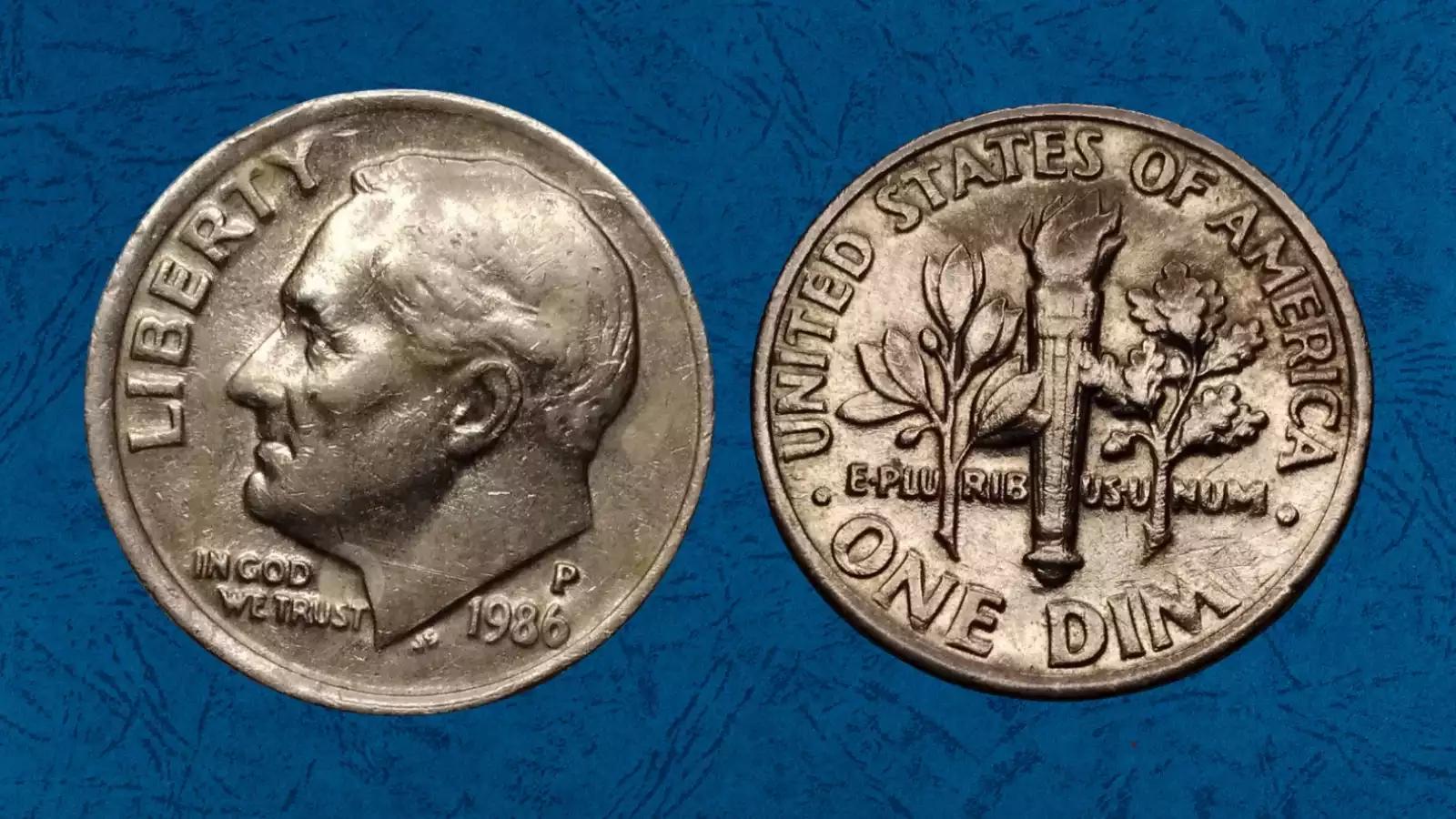 1986 Roosevelt dime broadstrike error showing expanded diameter beyond normal 17.9mm with smooth non-reeded edge